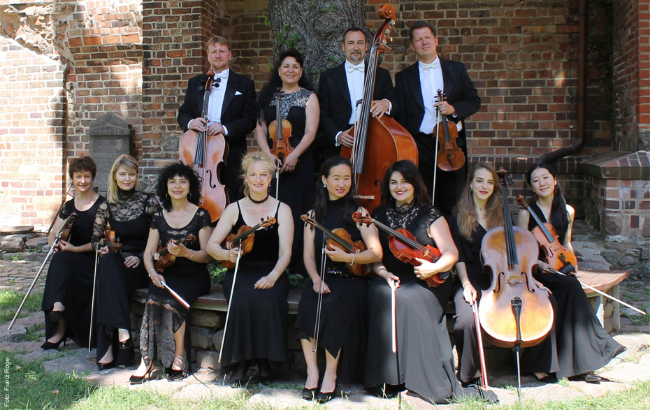 Gruppenfoto: Musiker mit Streichinstrumenten im Klostergarten