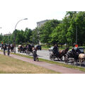Foto: Passanten beobachten die Kutschen bei der Fahrt durch die Lindenallee.